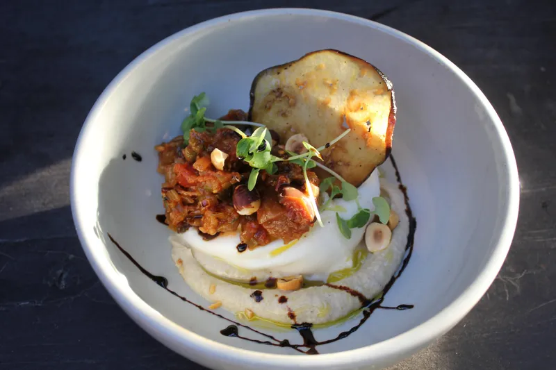 A plated share dish on a wood table